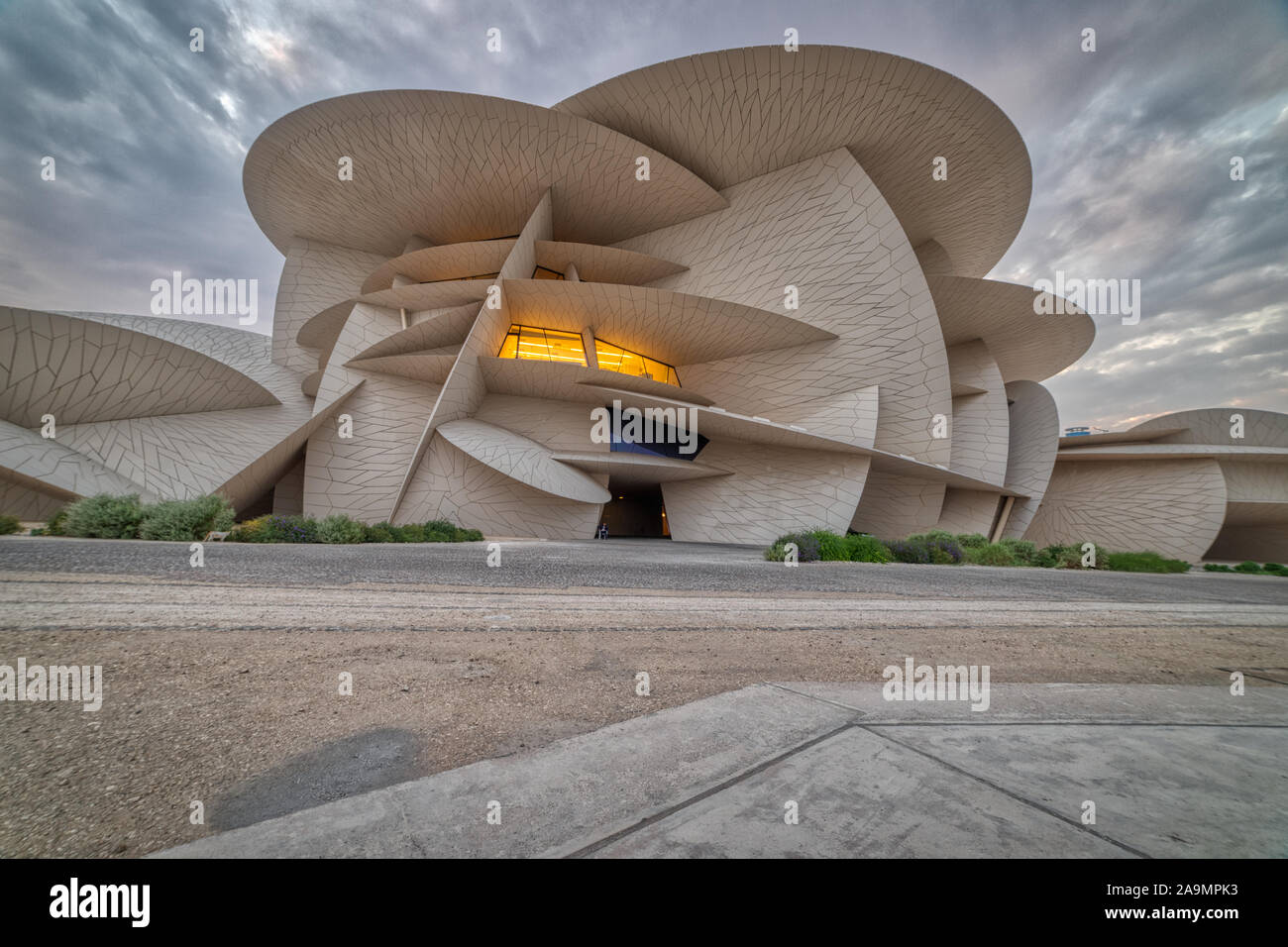 National Museum of Qatar (Desert rose) panoramic external view show the  unique architecture of museum at sunset with clouds in the sky in  background Stock Photo - Alamy