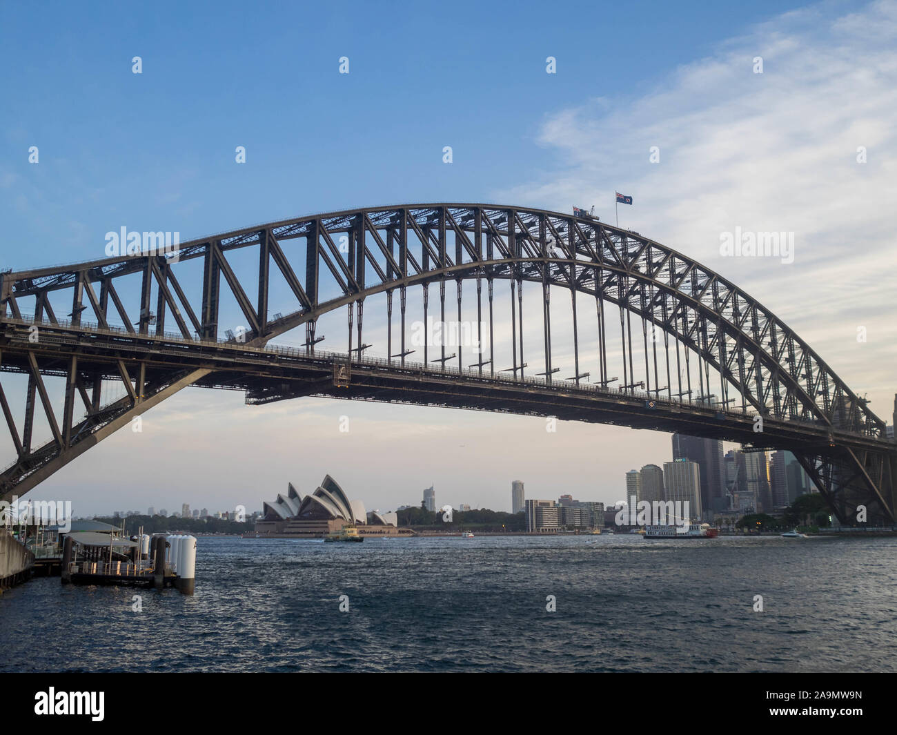 Sydney Harbour Bridge and the cityscape below seen from Milsons Point Stock Photo