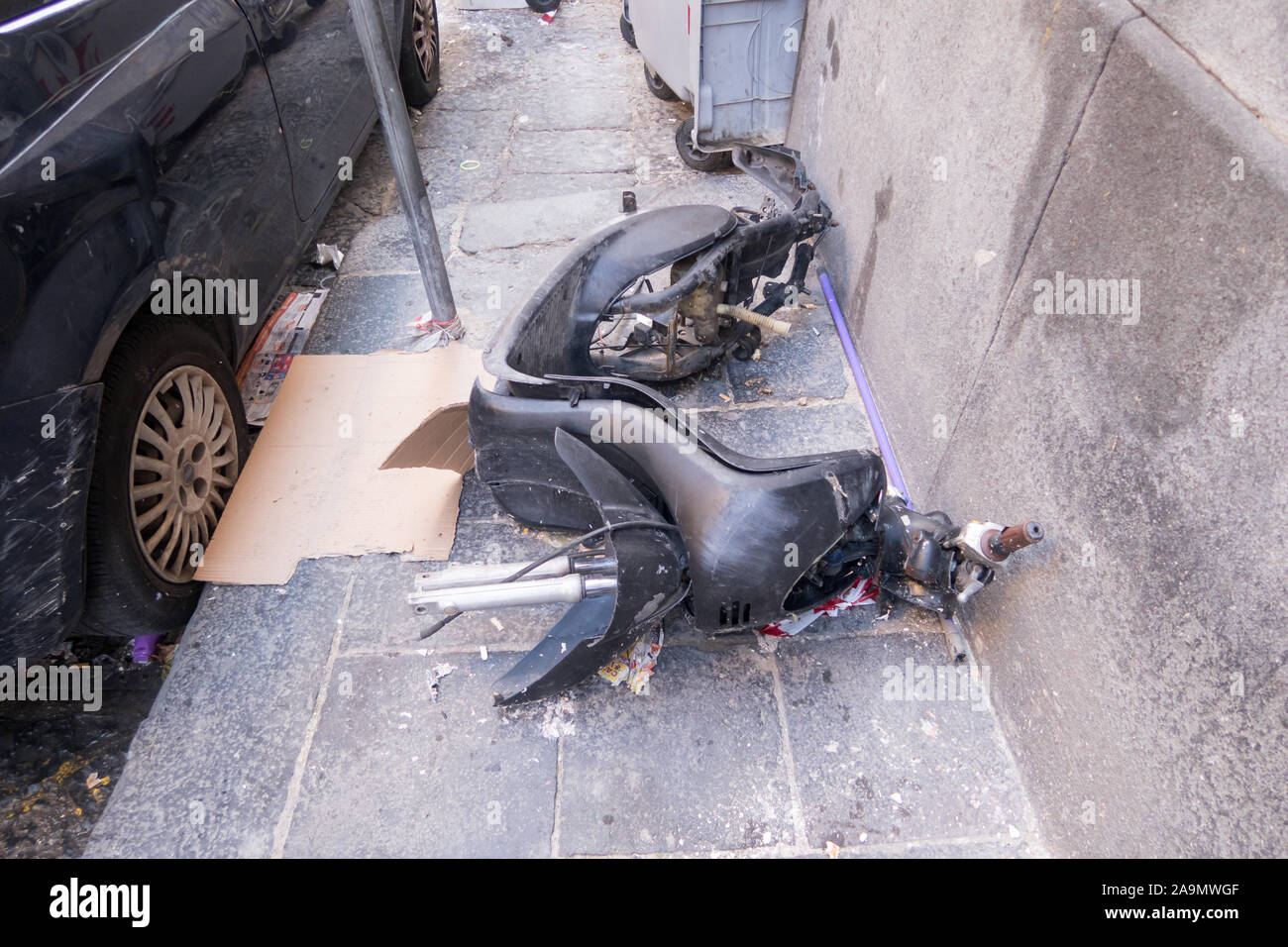 A destroyed moped left abandoned on a pavement in Naples city center Stock Photo