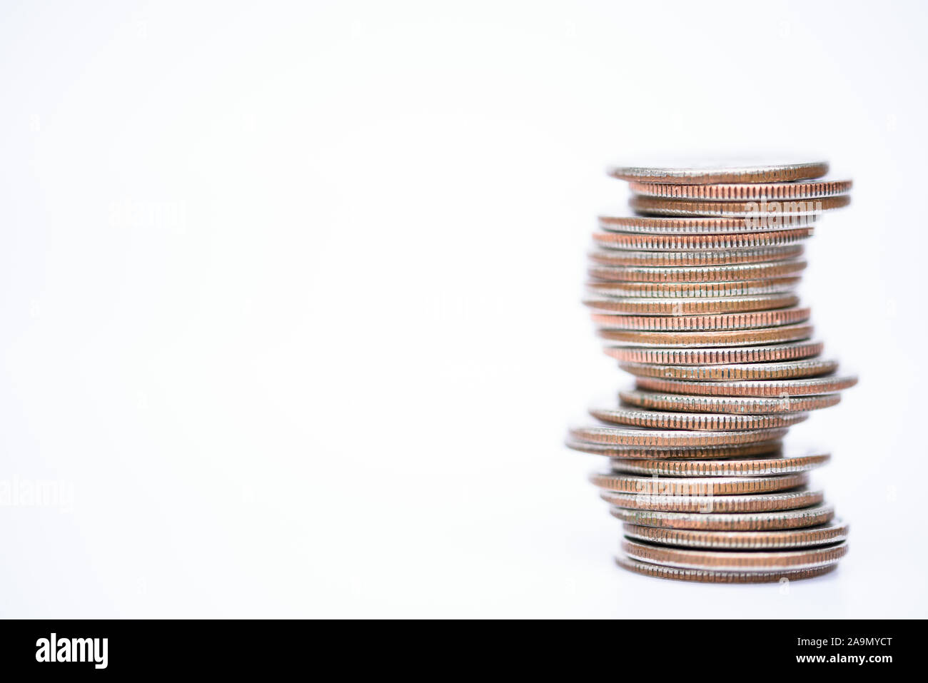 coins stacked on white background quarters and change Stock Photo