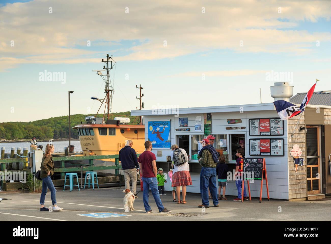 People waiting at Lobster and clam shack at ocean-front harbor, Castine, Maine, New England, USA Stock Photo