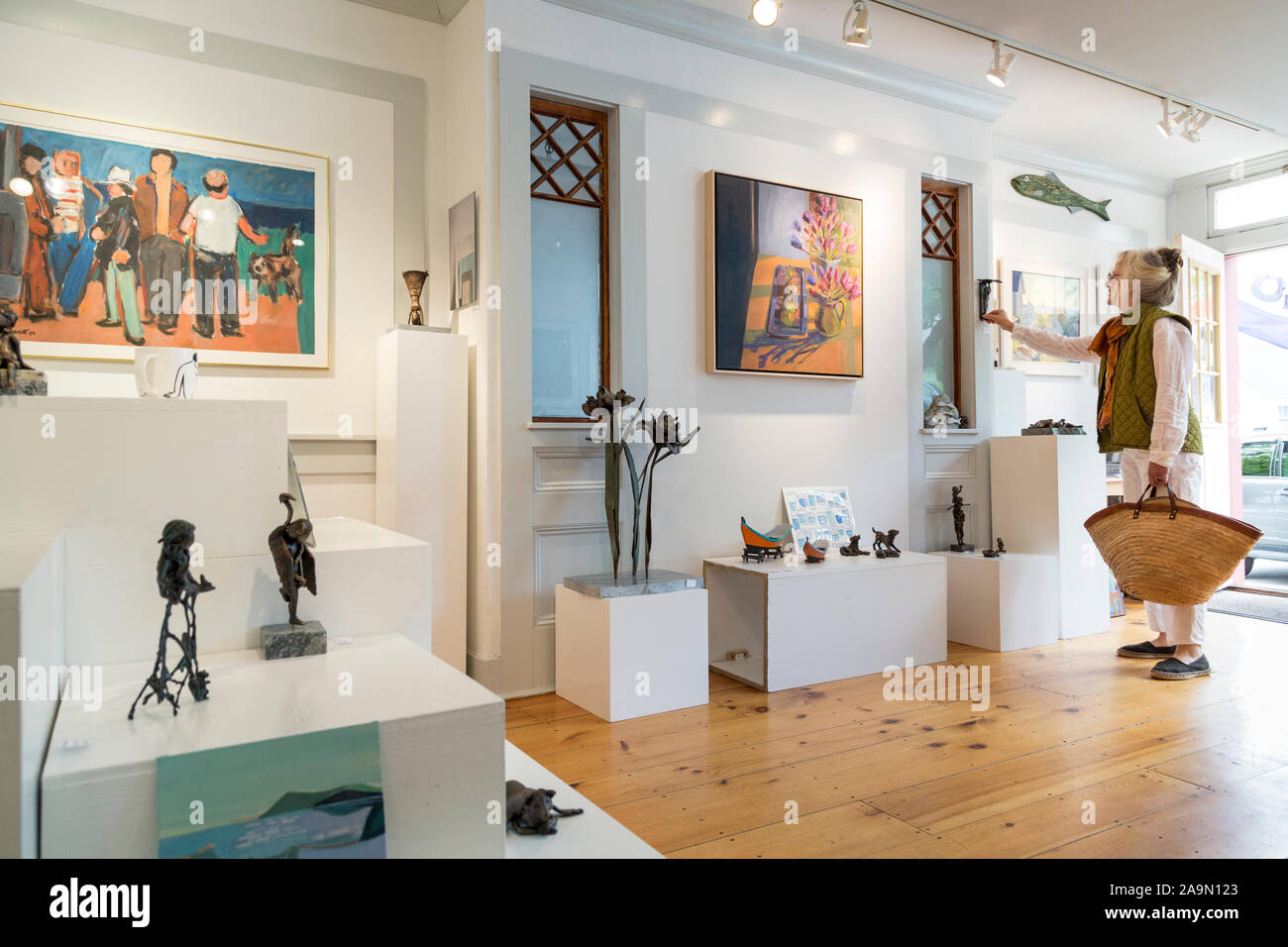Woman shopping in Art and Craft Gallery in Small Town , Castine, Maine, USA Stock Photo