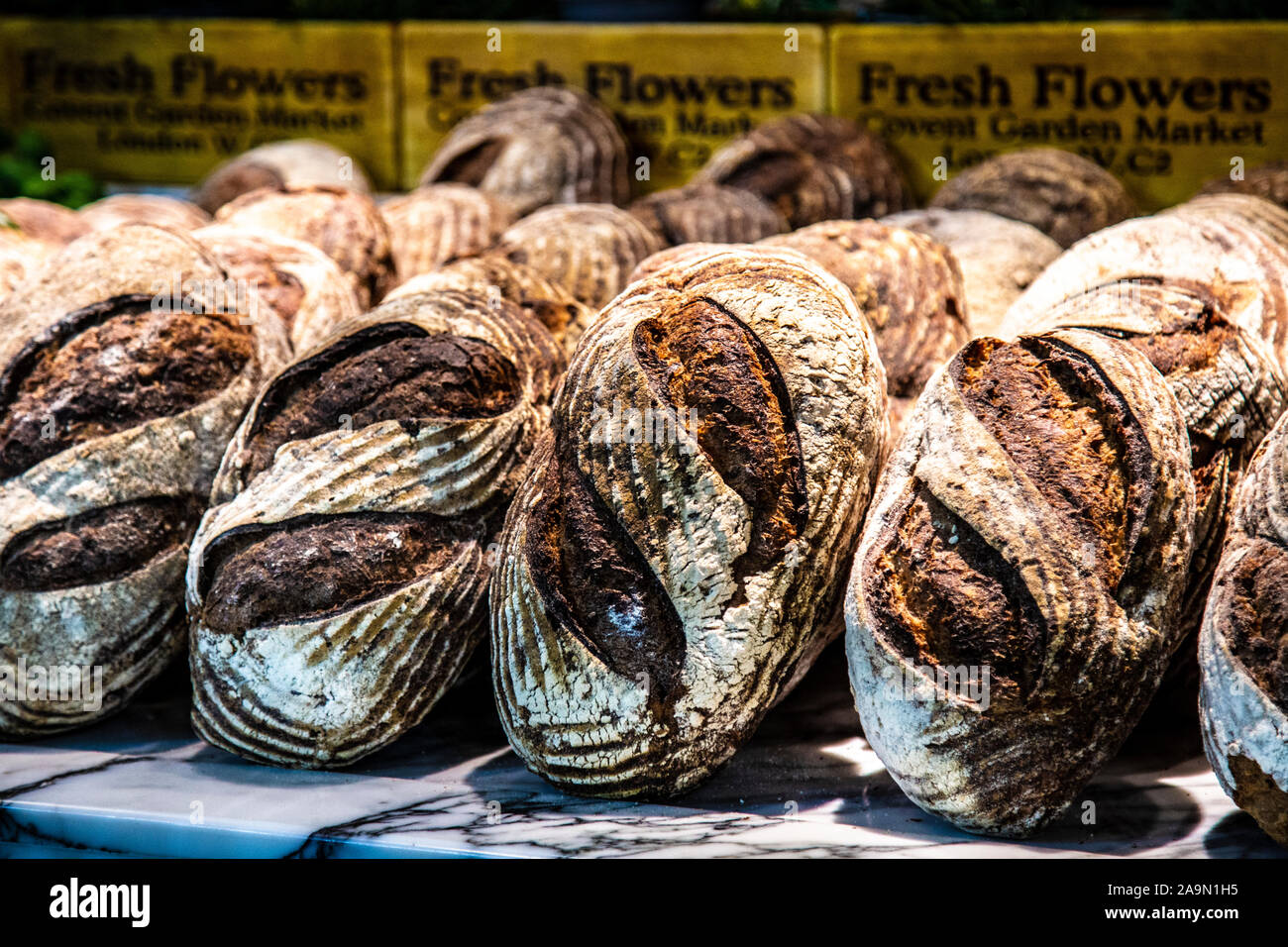 Fresh rustic loaves of bread at Buns & Buns restaurant, Covent Garden Market, London, UK Stock Photo