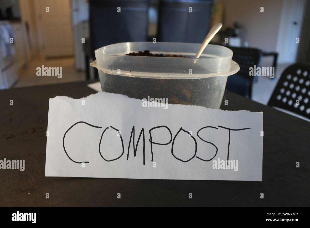 Photo of a container of used coffee grounds with a sign that says compost Stock Photo Alamy