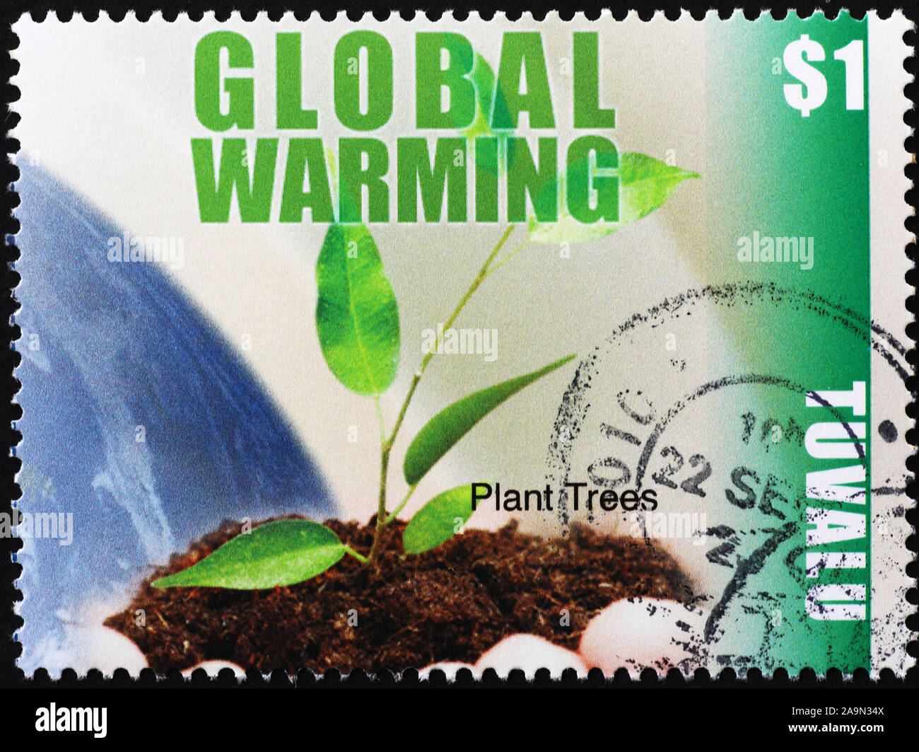 Exhortation to plant trees against Global Warming on stamp Stock Photo