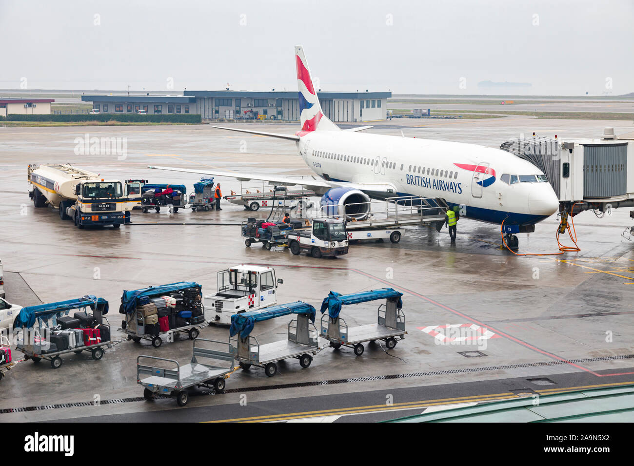 VENICE, ITALY - December 26, 2012. Baggage handlers load luggage onto a British Airways plane at Venice Marco Polo Airport, Venice, Italy Stock Photo