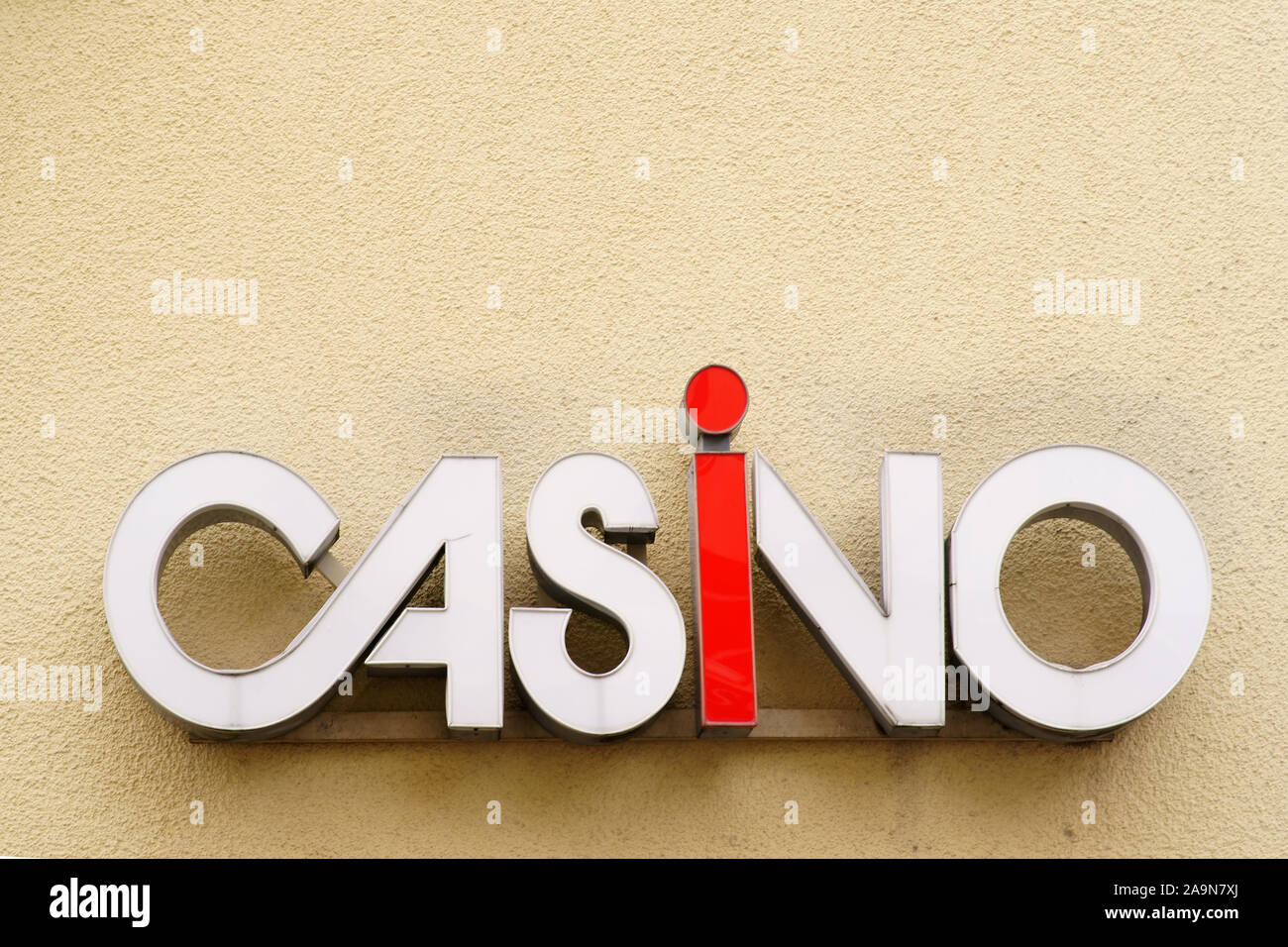 The closeup of a casino signboard on the yellow plaster of a facade. Stock Photo