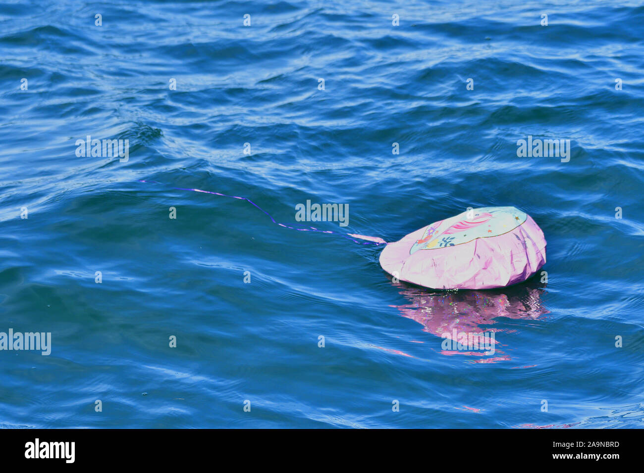 A Floating Balloon in the middle of the ocean Stock Photo