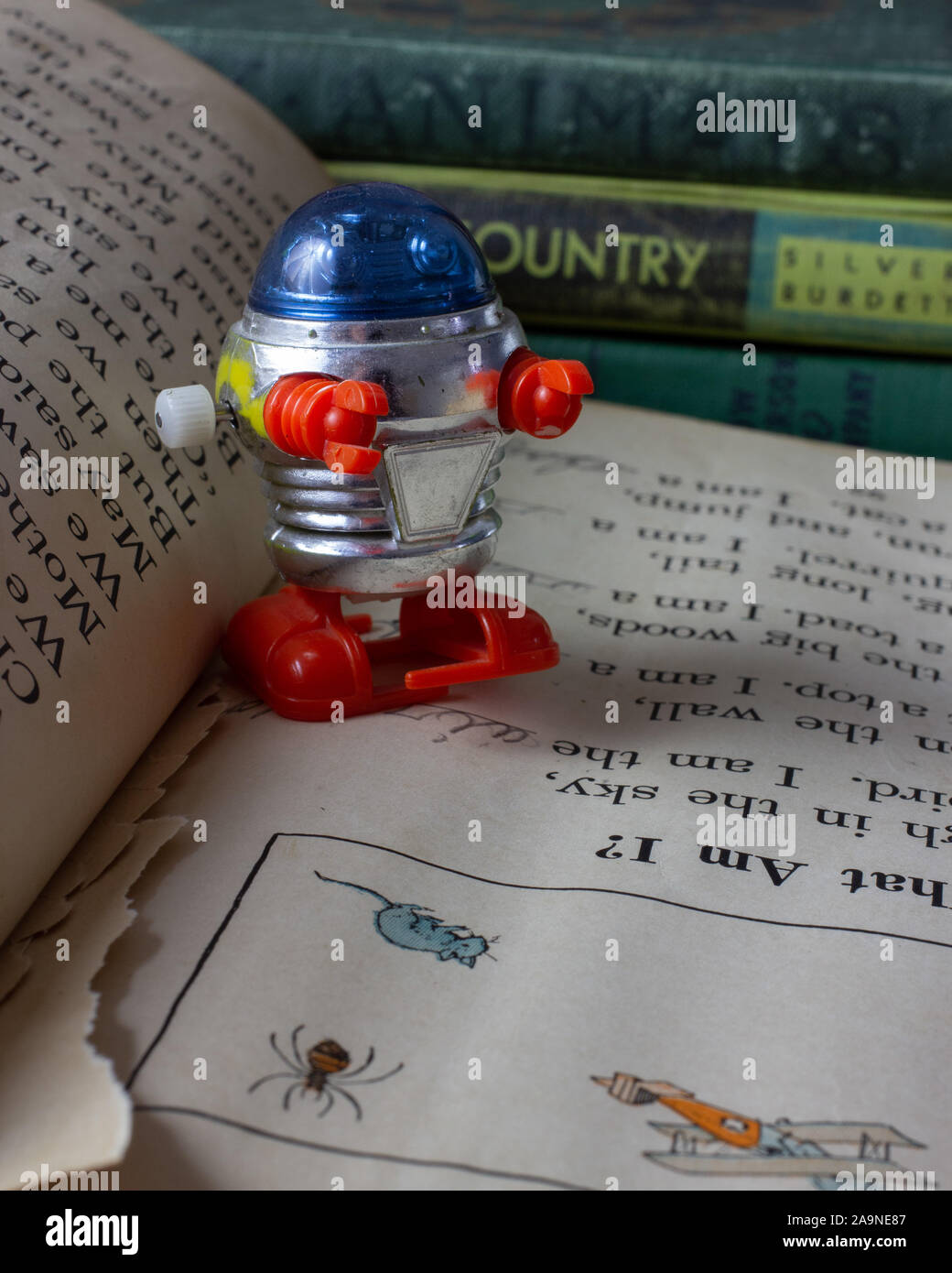 Tomy windup robot on an old reader Stock Photo