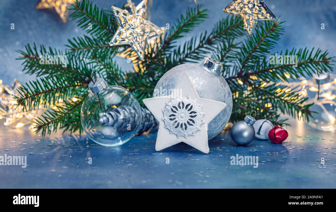 christmas decorations and green fir tree branch on blurred blue ...