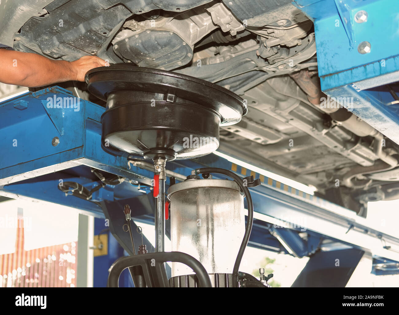 vehicle lift up by hydraulic for motor oil change and transmission inspection. changing engine