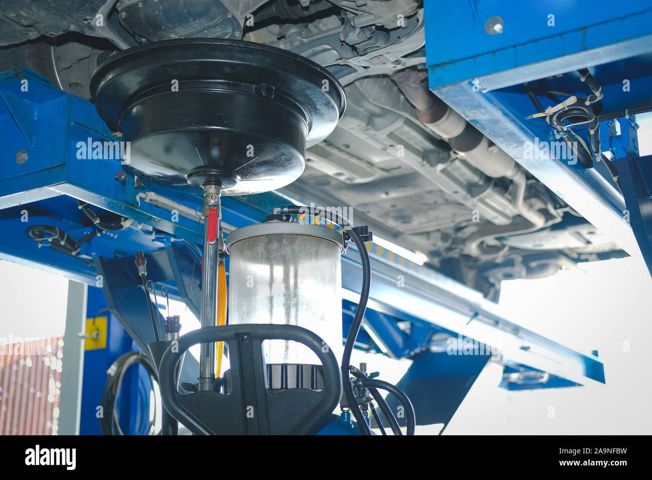 vehicle lift up by hydraulic for motor oil change and transmission inspection. changing engine