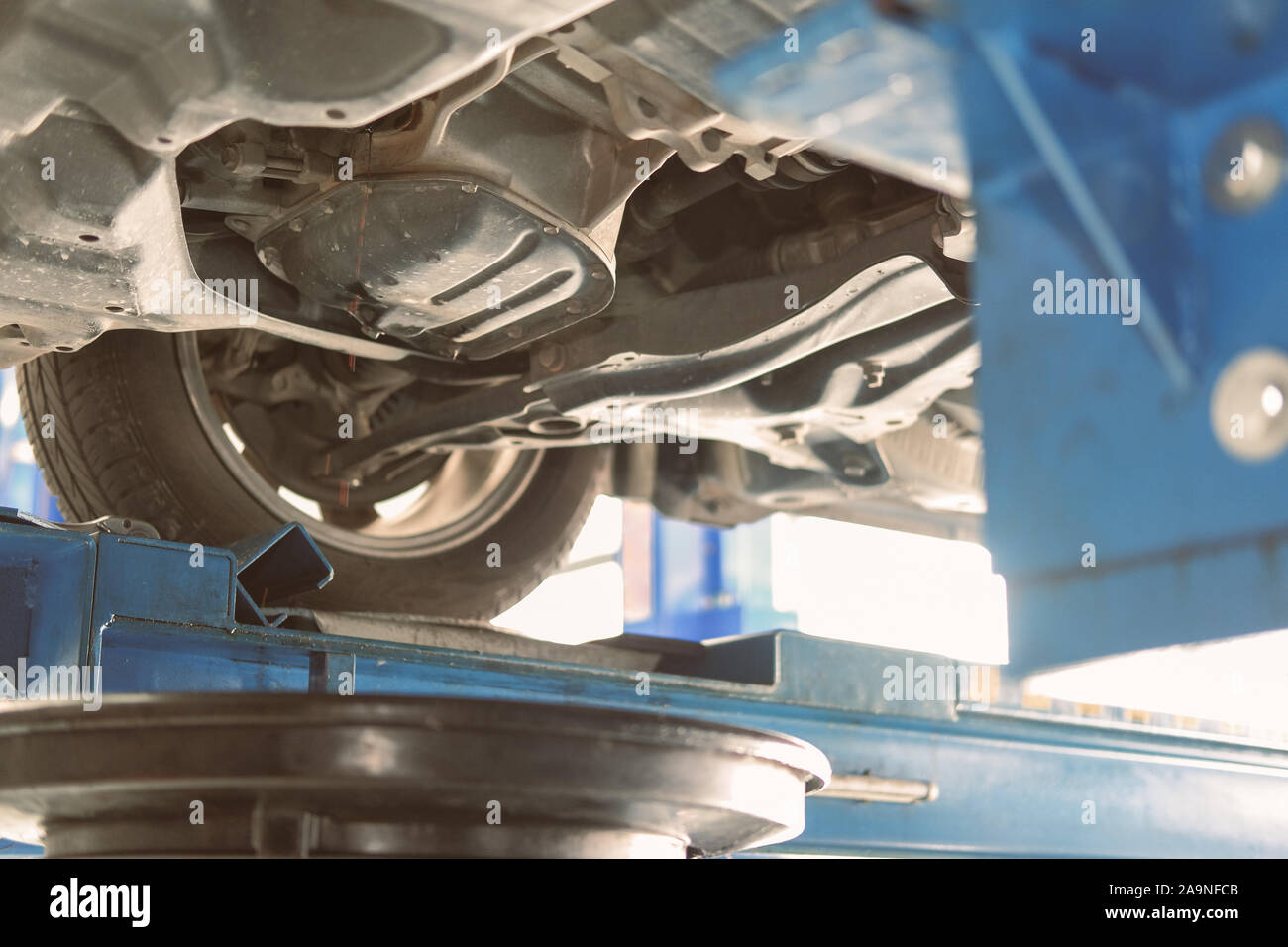 vehicle lift up by hydraulic for motor oil change and transmission inspection. changing engine