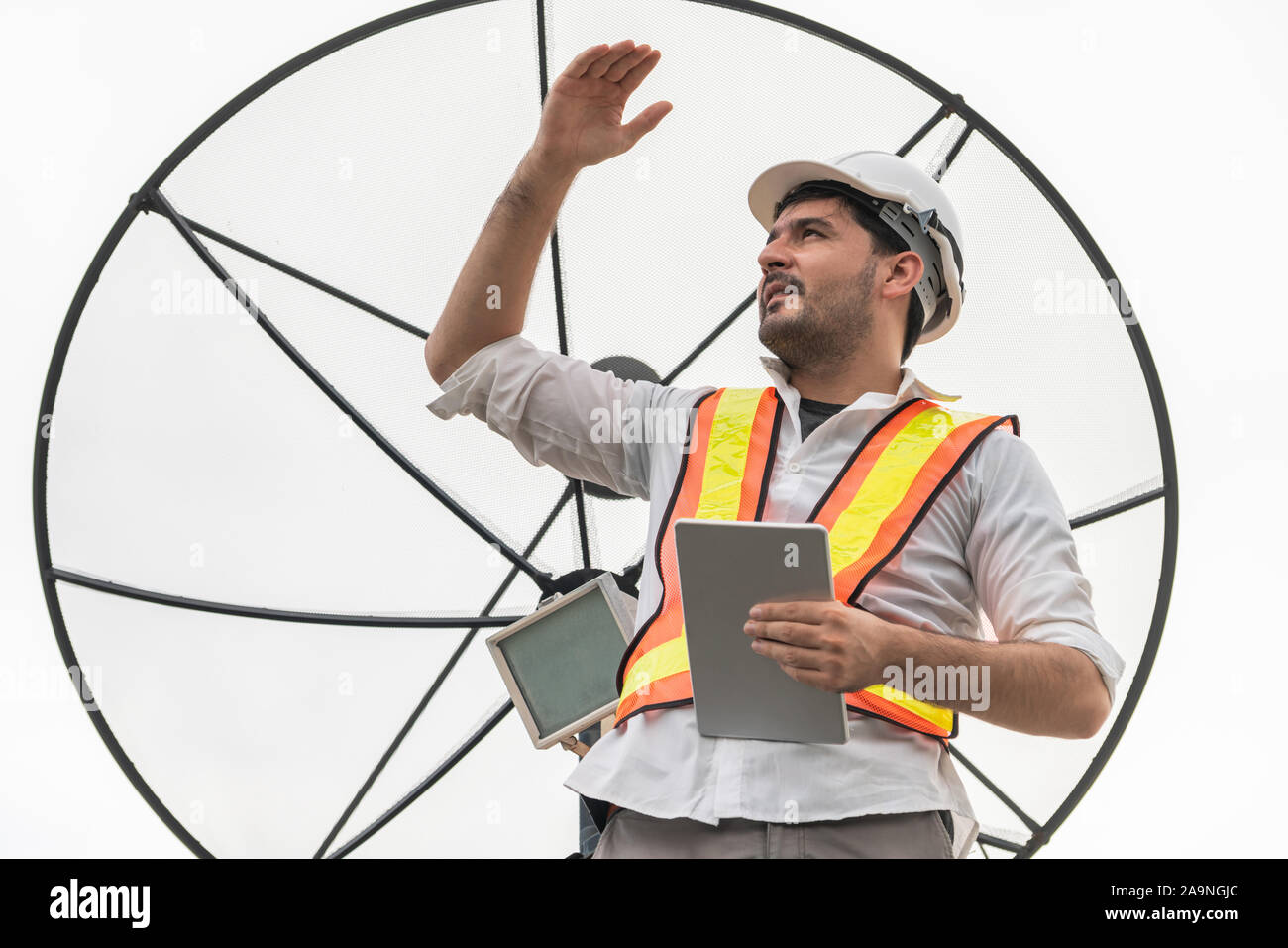 Professional technician or engineer standing on roof top of building