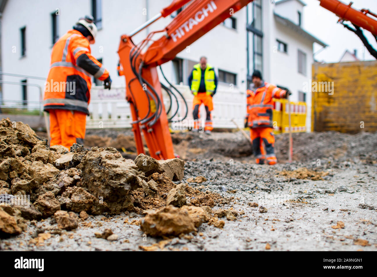 Bielefeld, Germany. 13th Nov, 2019. Three construction workers install a house connection for rainwater and wastewater at a construction site in Schlosshofstraße in Bielefeld. Schlosshofstrasse is currently being renovated and the residents will share in the costs. Since the city of Bielefeld classifies the street as a residential street, the contributions for the property owners will be particularly high. (to dpa 'The bone of contention road construction contribution - pensioners anxious for old-age security') Credit: David Inderlied/dpa/Alamy Live News Stock Photo