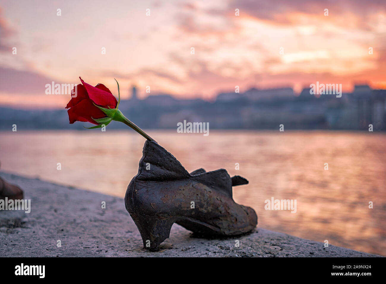 "Shoes on the Danube bank" Monument as a memorial of the victims of the Holocaust during WWII on the bank of the Danube at sunset in Budapest, Hungary Stock Photo