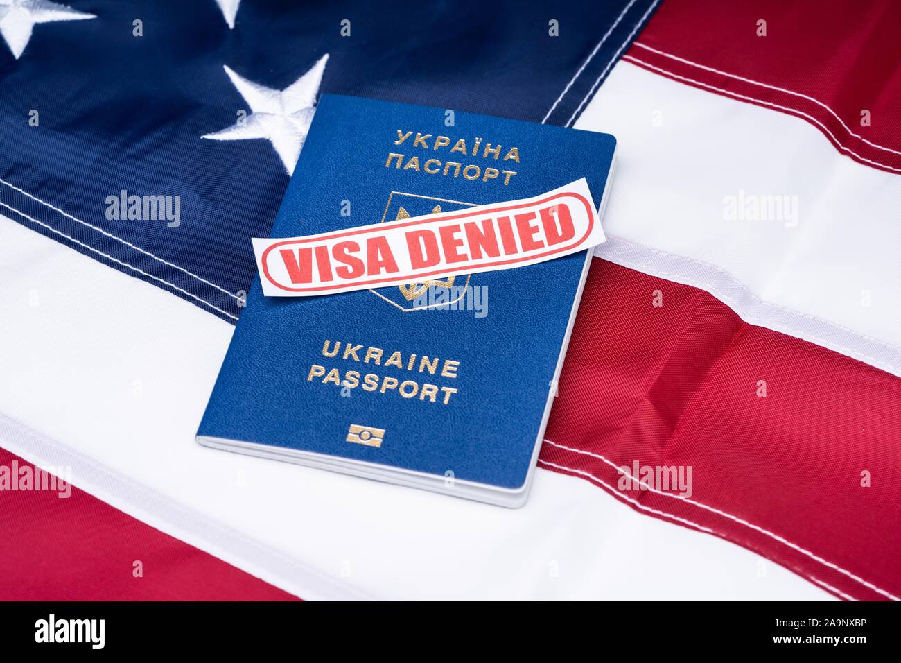 Overhead View Of Visa Denied Text And Ukraine Passport Over American Flag Background Stock Photo