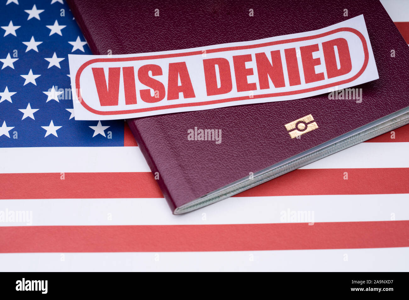 Note Paper With Visa Denied Text And Passport Over American Flag Background Stock Photo
