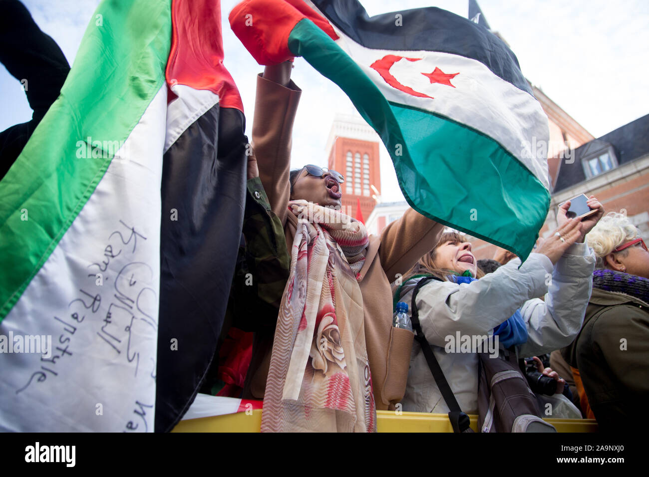 Madrid, Spain. 16th Nov, 2019. Saharawi woman with flags during the demonstration.Thousands of Saharawis arrive from all over Spain to demand the end of Morocco's occupation in Western Sahara, the freedom of political prisoners, in support of the Polisario Front and to demand solutions from the Spanish government. Western Sahara was a Spanish colony until 1976 where Spain left the territory. Later Morocco occupied part of Western Sahara and still part of the Saharawi population lives in refugee camps in the desert in Algeria and in Spain. Credit: SOPA Images Limited/Alamy Live News Stock Photo