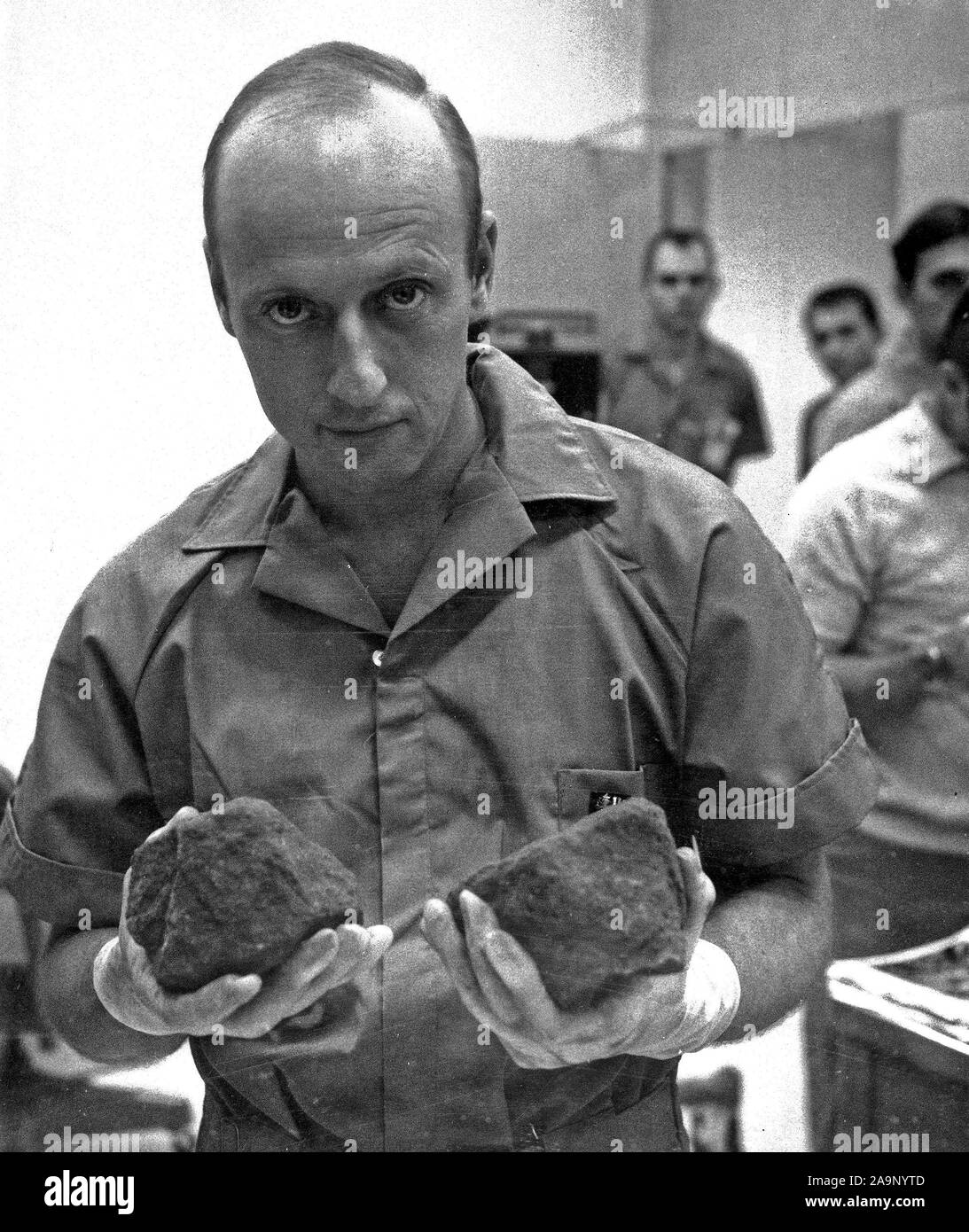 (29 Nov. 1969) --- Astronaut Charles Conrad Jr., commander of the Apollo 12 lunar landing mission, holds two lunar rocks which were among the samples brought back from the moon by the Apollo 12 astronauts. Stock Photo