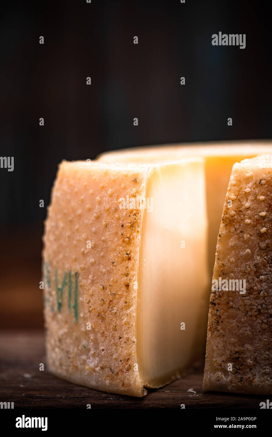 Aged Hard Cheese Wheel and Triangle Cut. Diary Cellar and Local Produce. Stock Photo