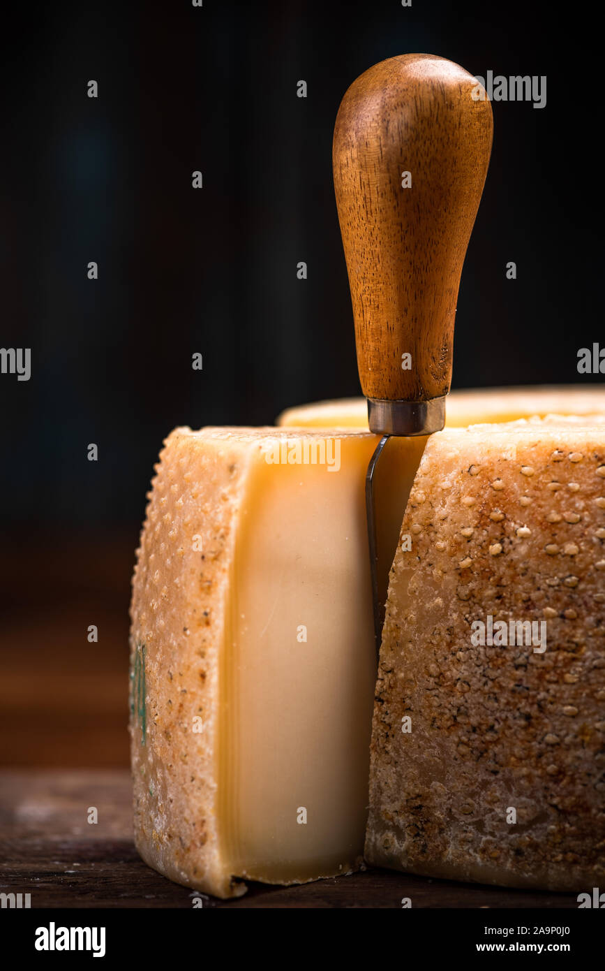 Hard Matured Cheese Wheel. Local Traditional Food Production in Diary Cellar. Stock Photo