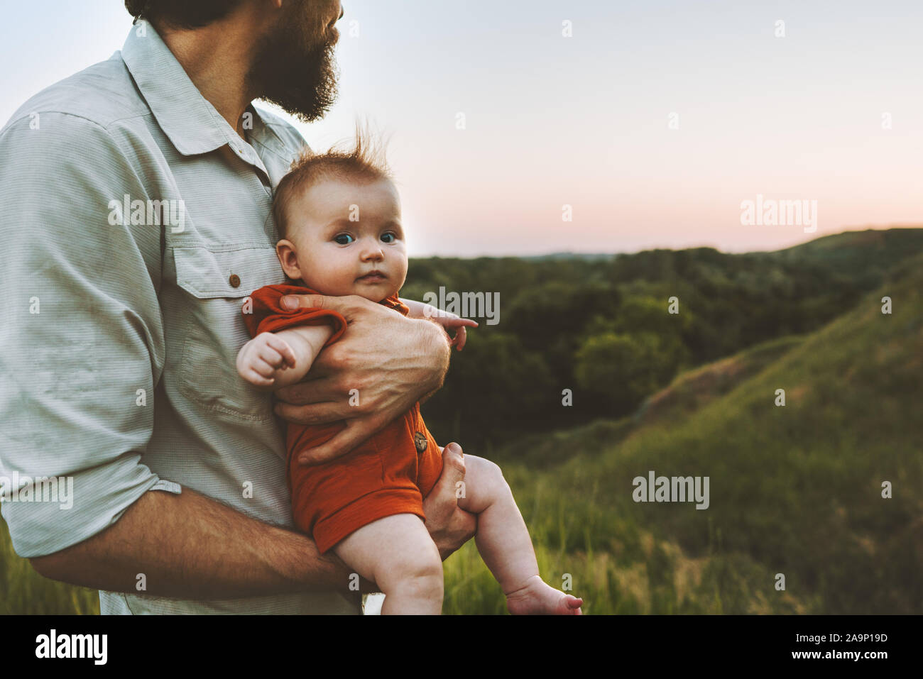 Father walking with baby outdoors family lifestyle dad and child together summer vacations parenthood childhood concept Fathers day holiday Stock Photo