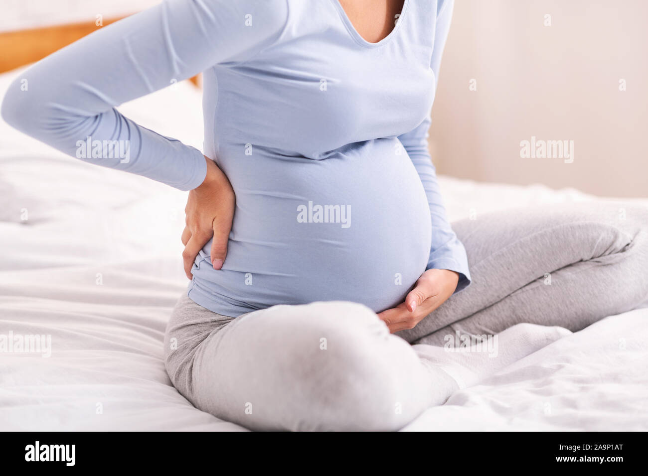 Pregnant Lady Having Backache Sitting On Bed In Bedroom, Cropped Stock Photo Alamy