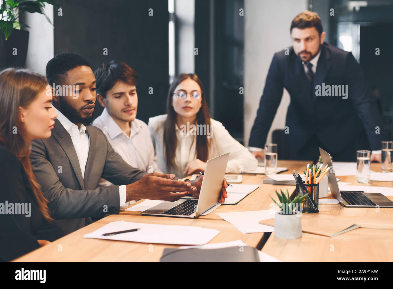 Diverse business colleagues discussing paperwork hi-res stock ...