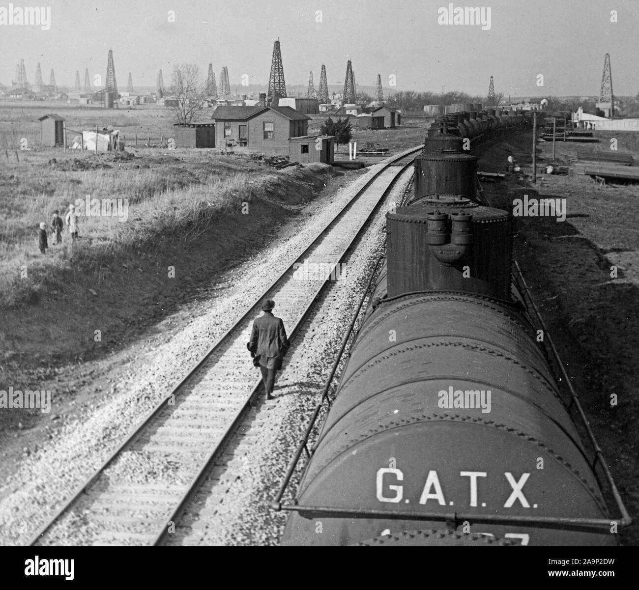 A steel tank train conveying cured oil from the wells in the Yale Field in Oklahoma to refinery. Each car contains 10, 000 gallons. The annual production of mineral oil in the United States is approximately eleven billion gallons, or 65 percent of the world's output. March 25, 1918 Stock Photo