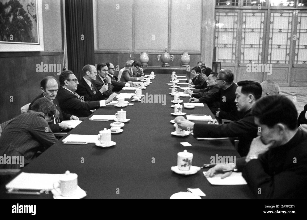 This photograph depicts President Ford, Secretary of State Henry Kissinger, Chief U.S. Liaison Officer George H. W. Bush and the President's staff as they hold bilateral talks with People's Republic of China (PRC) Vice-Premier Teng Hsiao-P’ing and other officials in the Great Hall of the People. Stock Photo
