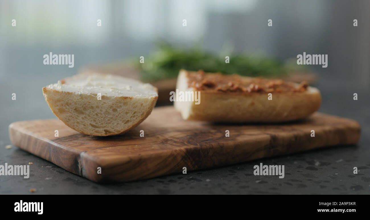 ciabatta sandwich with red pesto and cream cheese on terrazzo