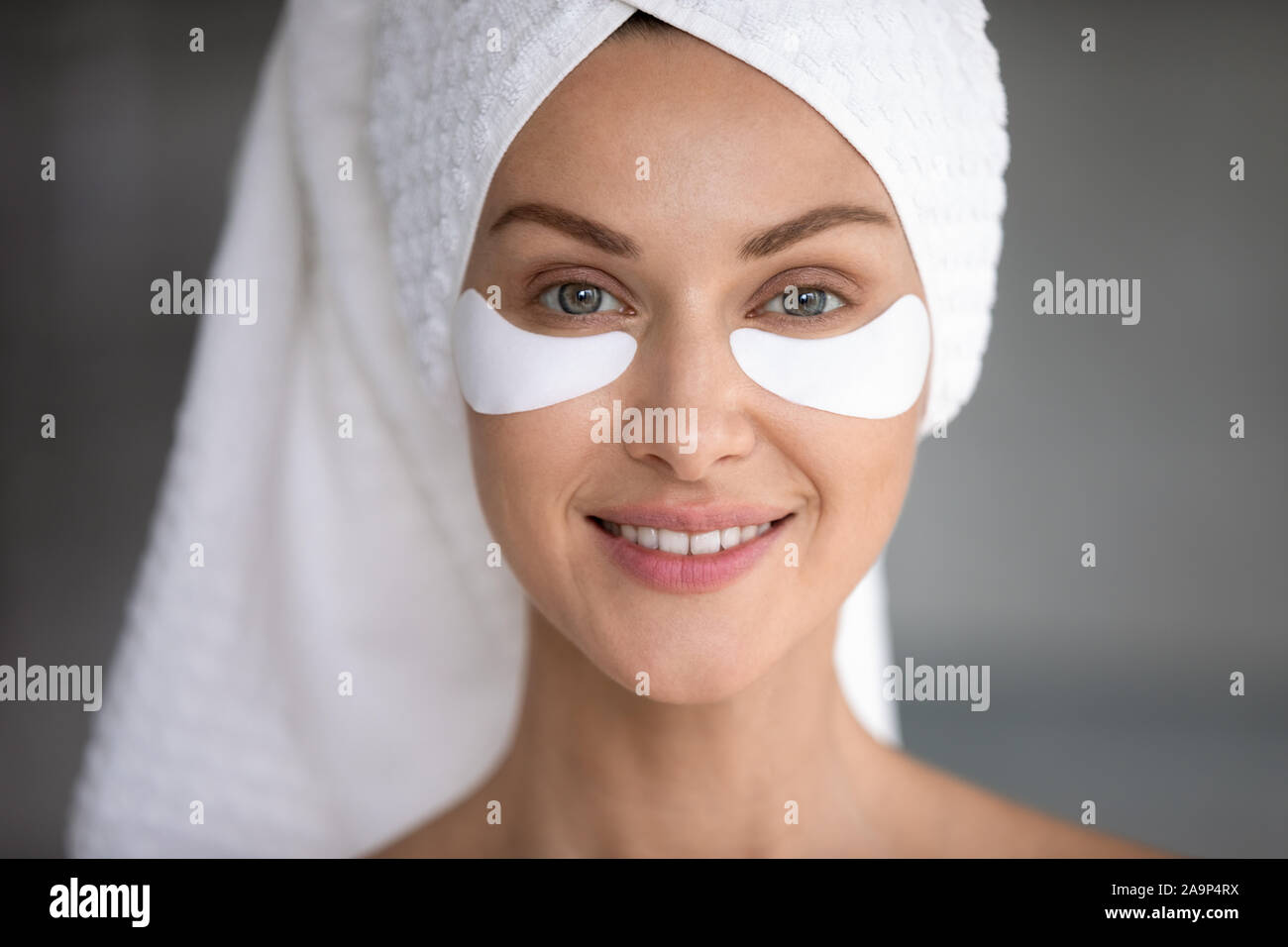 Smiling lady look at camera with eye patches on face Stock Photo Alamy