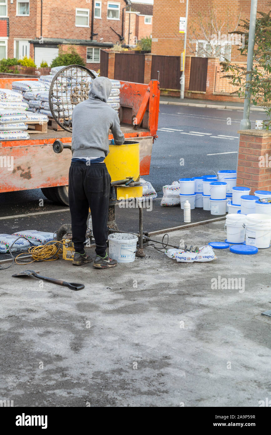 https://c8.alamy.com/comp/2A9P59R/a-man-using-a-forced-action-mixer-to-mix-resin-for-laying-a-driveway-in-stockton-on-teesenglanduk-2A9P59R.jpg