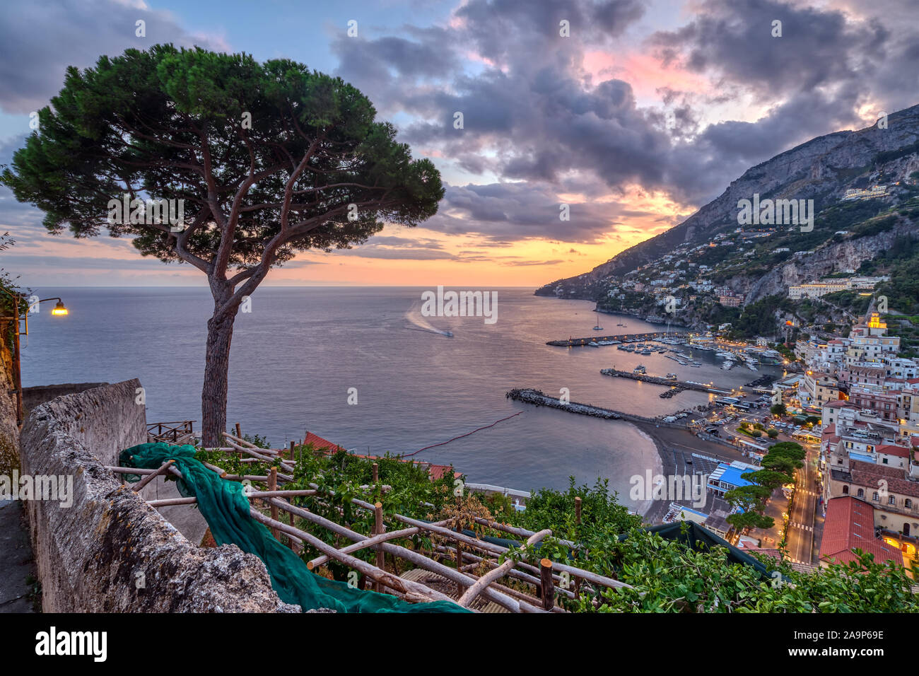 View of Amalfi in Italy at sunset with a lone pine tree Stock Photo