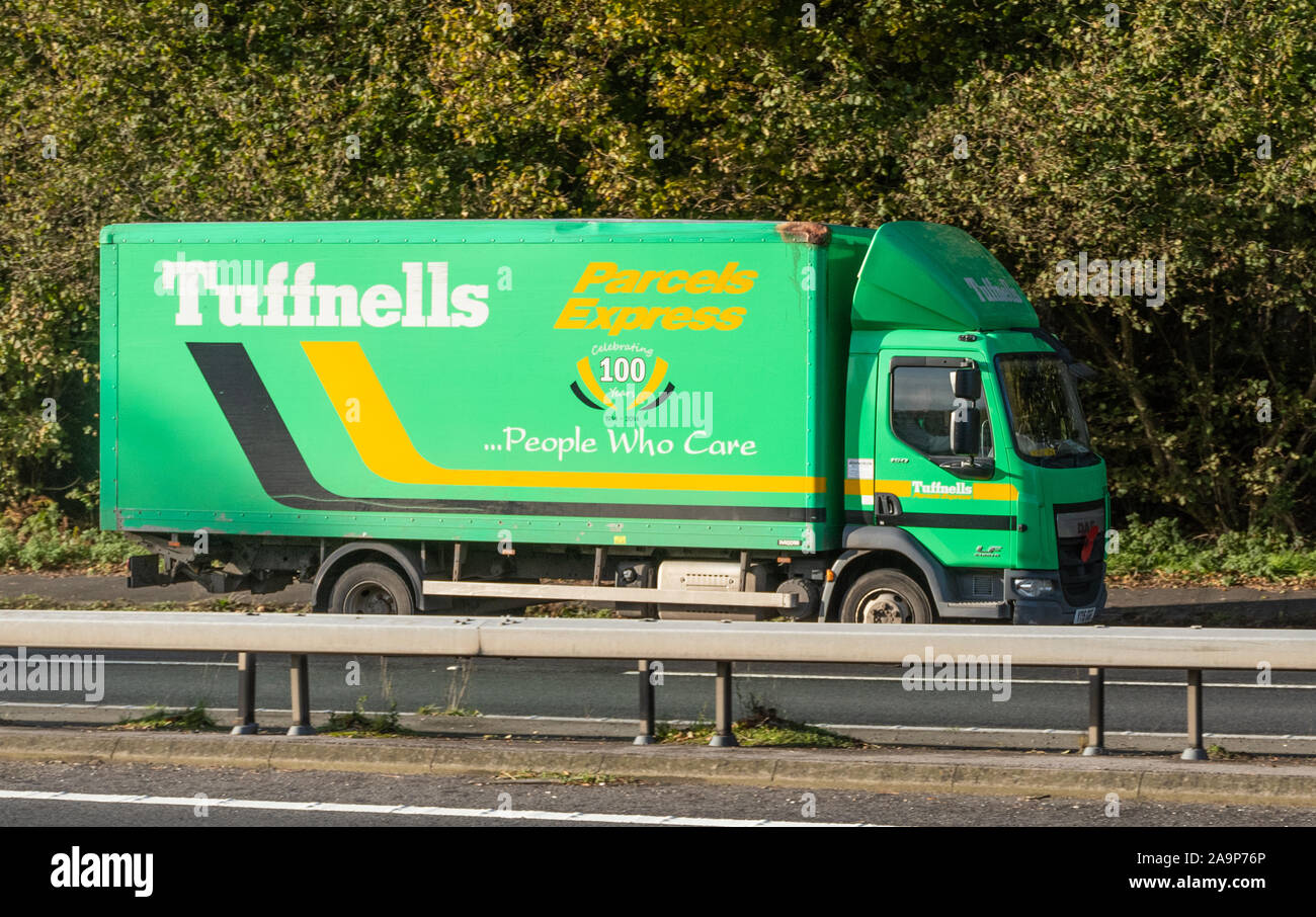 Tuffnells Parcels Express lorry or truck driving along a dual carriageway, UK Stock Photo