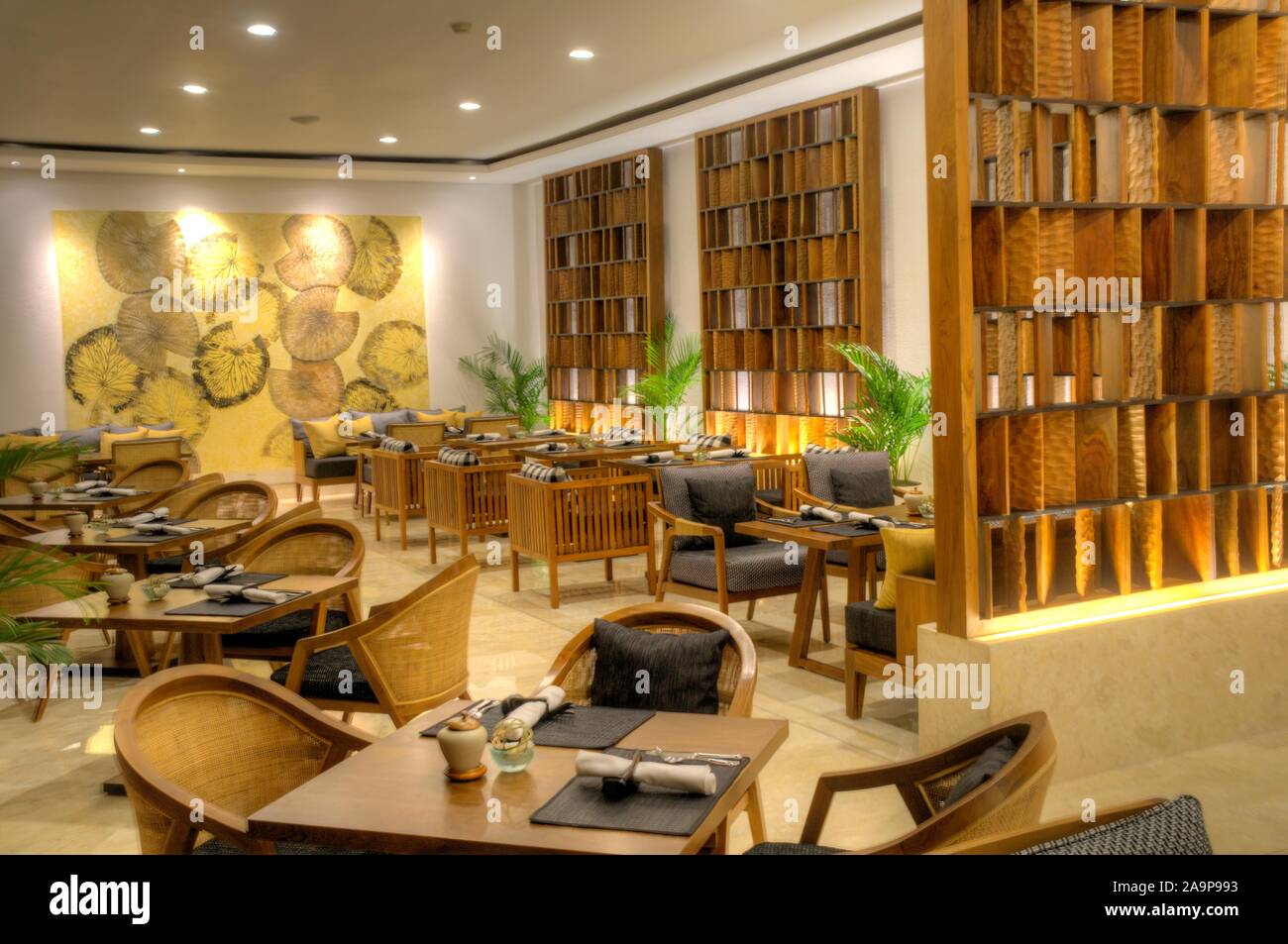 restaurant interior with tables and chairs and paintings at night Stock ...