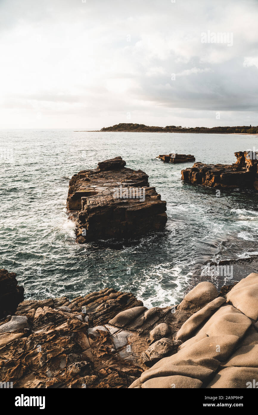 The rocky cliff edge between Turners Beach and Yamba Beach at Clarence