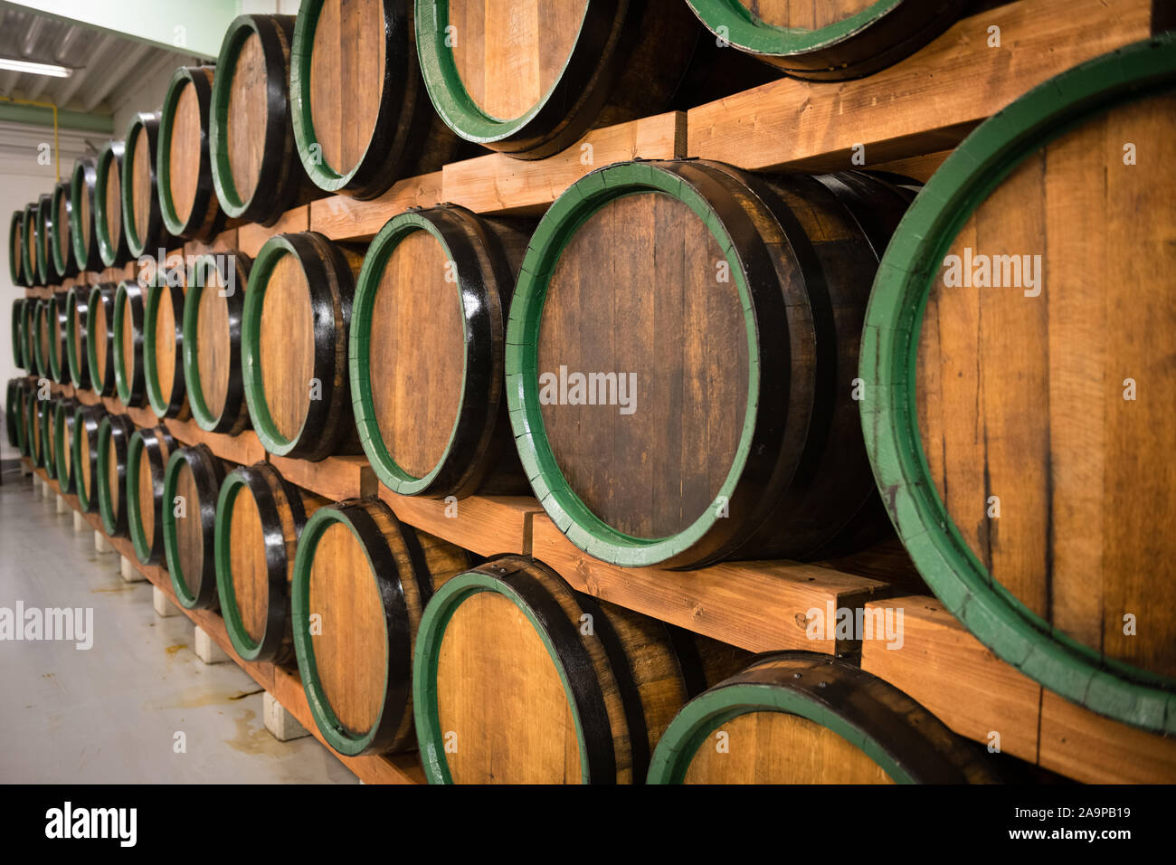 Wooden wine barrels for storage in wine cellar Stock Photo Alamy