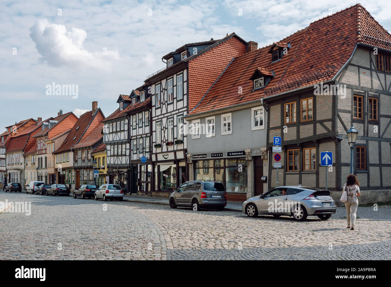 View of a paved street and beautiful colorful half-timbered houses of the old town Quedlinburg. Stock Photo