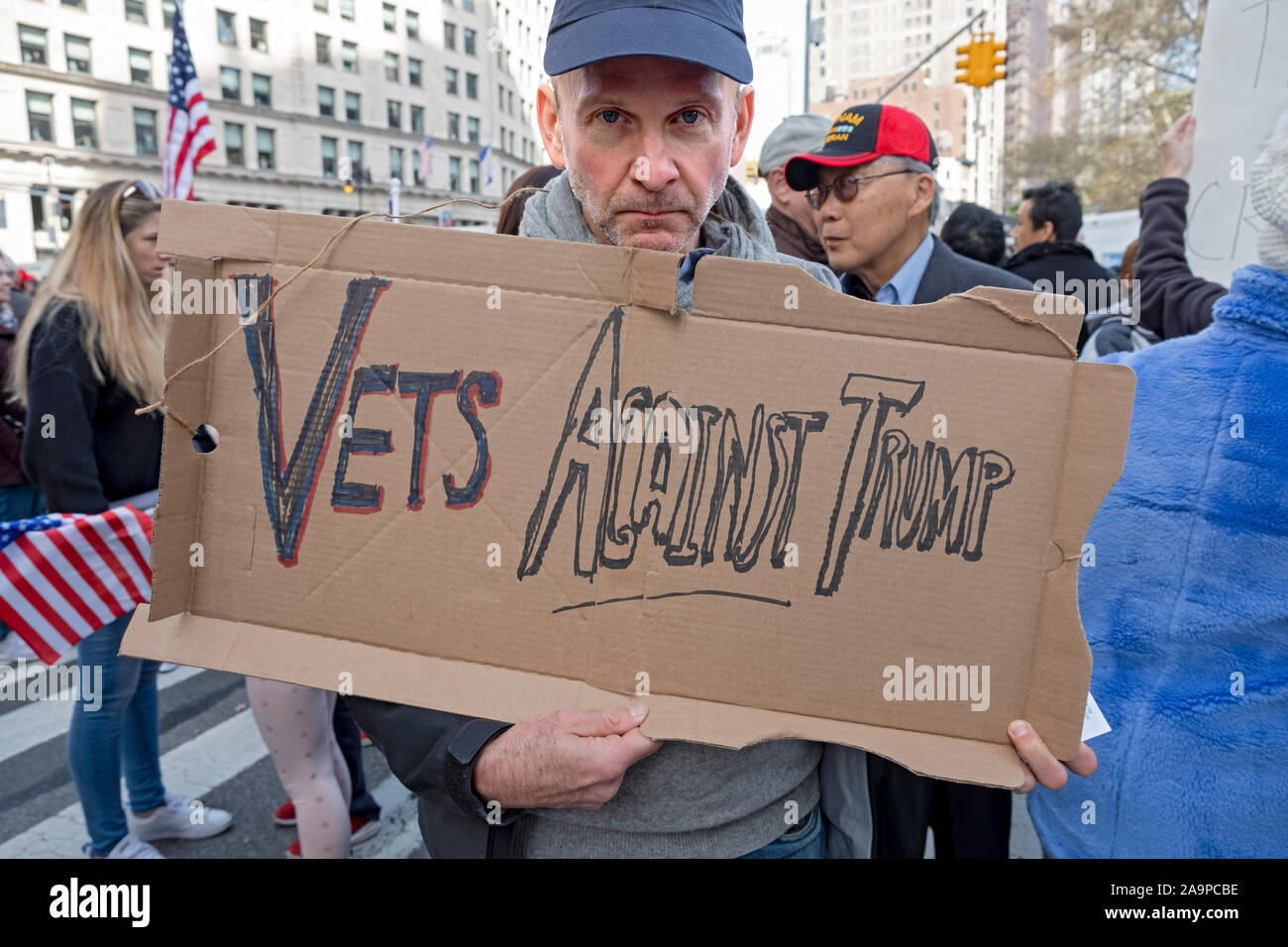 An angry veteran carries a homemade VETS AGAINST TRUMP sign at the Veteran's Day parade on Fifth Avenue in Manhattan, New York City Stock Photo