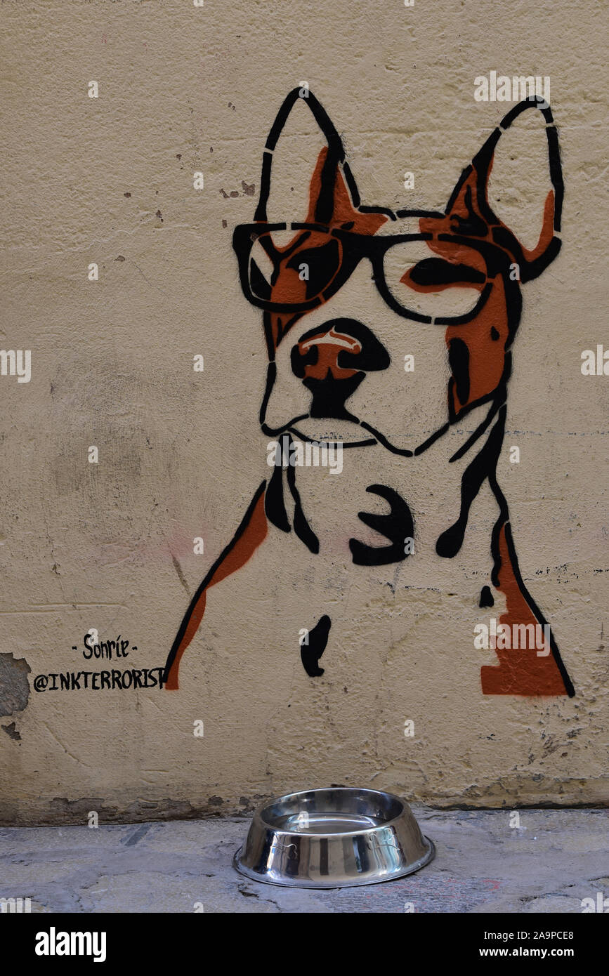 Canine artwork by Sonríe, @inkterrorist, outside a cafe, indicating a drinking station for dogs, in the streets of Old Town Palma, Spain, Europe. Stock Photo