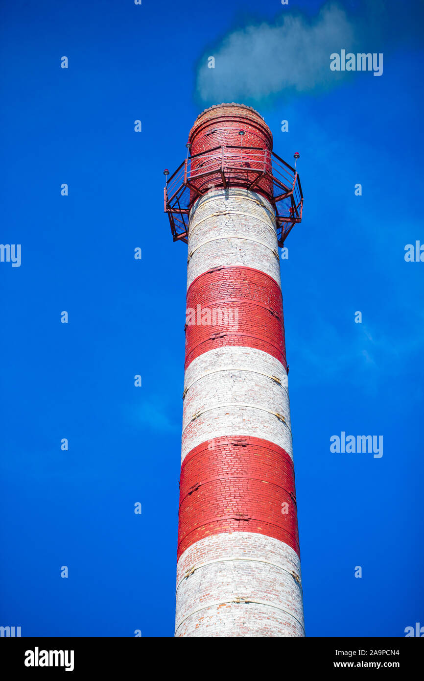 Vertical factory chimney with smoke Stock Photo