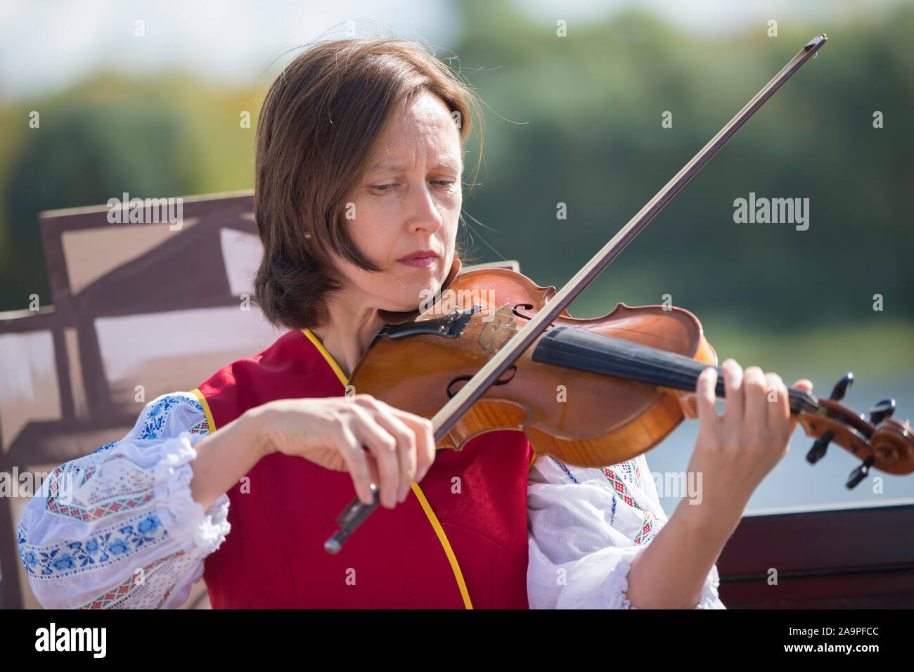 Belarus, the city of Gomil, September 14, 2019. City holiday. Slavic woman street musician. Ukrainian or Belarusian girl in an embroidered shirt plays Stock Photo