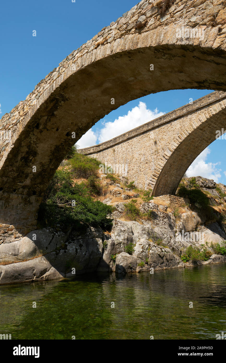 Ponte Altu / Ponte Altu is a Genovese bridge over the river Golo in Albertacce, Haute-Corse, Corsica France Europe with the adjacent newer road bridge Stock Photo