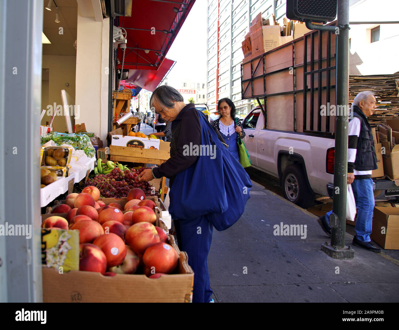 Shoppers at the street market in San Francisco's China Town going about their daily chores Stock Photo