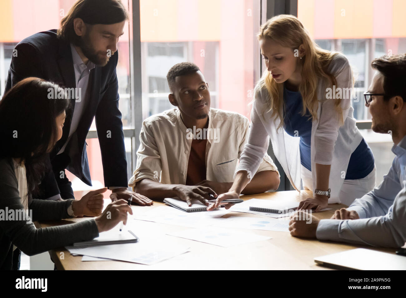Mixed race man talking teammates hi-res stock photography and images ...