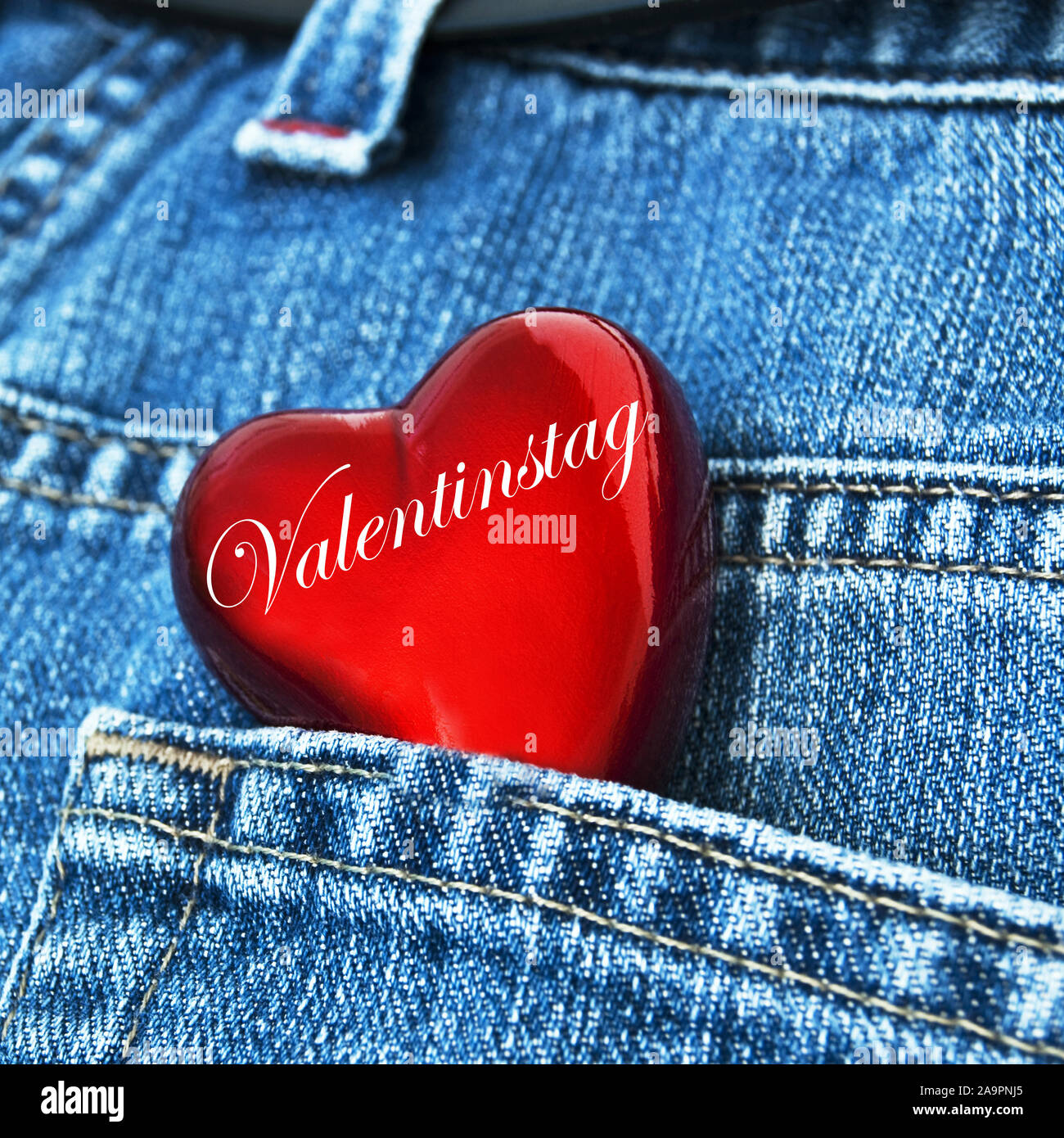 German Valentine's Day red heart in jeans pocket Stock Photo
