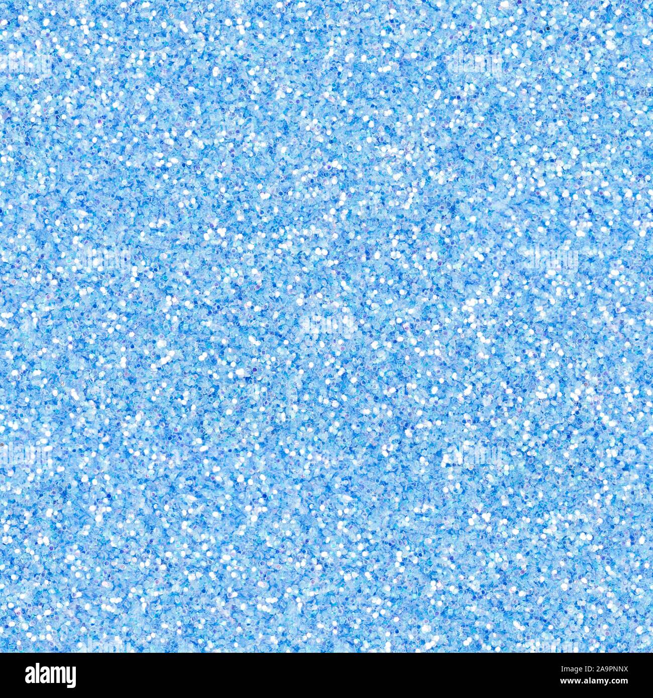 Bright light blue glitter, sparkle confetti texture. Christmas abstract