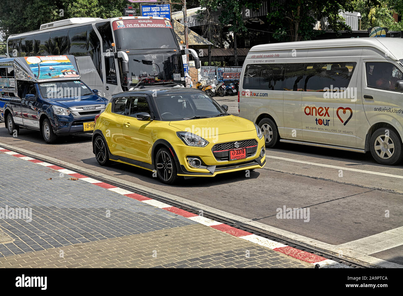Suzuki Swift yellow compact Japanese car with Thailand red number plate signifying a new vehicle Stock Photo